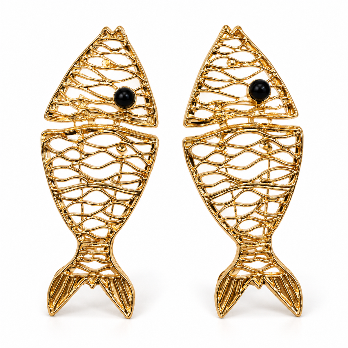 Articulated wave-lattice gold fish earrings with black onyx eyes on pure white background