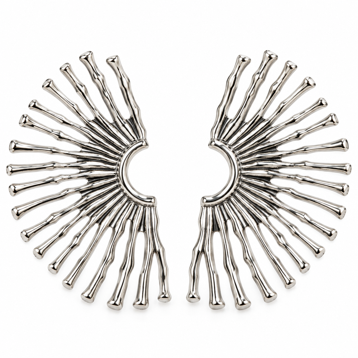 Avant-garde sunburst spike ear cuffs in polished silver finish on pure white background