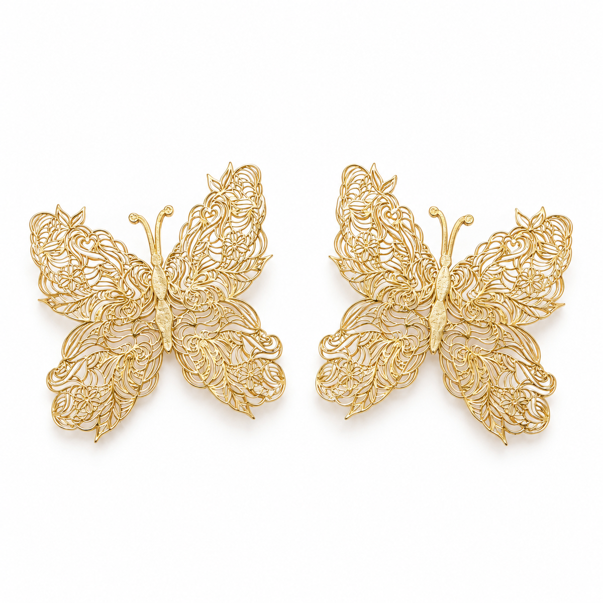 Ethereal filigree butterfly wing gold statement earrings on pure white background